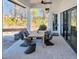 Covered patio with stylish outdoor seating perfect for entertaining guests at 3949 Bulow Landing Rd, Ravenel, SC 29470