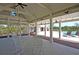 Inviting pool area under a covered porch, complete with lounge chairs and rocking chairs for relaxation at 3949 Bulow Landing Rd, Ravenel, SC 29470