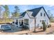 Rear exterior showcasing a pool, a covered patio, and well-maintained landscaping at 3949 Bulow Landing Rd, Ravenel, SC 29470