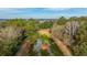 An aerial view of lush green trees surrounding a unique pond with a small island in the center at 3970 Betsy Kerrison Pkwy, Johns Island, SC 29455