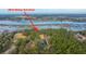 Aerial view with an arrow pointing toward the property at 3970 Betsy Kerrison and its pond at 3970 Betsy Kerrison Pkwy, Johns Island, SC 29455