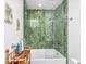 Unique bathroom with green tile shower, bathtub, and custom shelving at 3970 Betsy Kerrison Pkwy, Johns Island, SC 29455