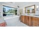 Bright bathroom features a soaking tub with a large window view of the pool and waterway at 3970 Betsy Kerrison Pkwy, Johns Island, SC 29455