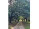 A long, tree-lined driveway creates a serene entry to this charming property at 3970 Betsy Kerrison Pkwy, Johns Island, SC 29455