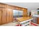 A bright kitchen with marble countertops, wooden cabinets, stainless steel fridge, and kitchen island at 3970 Betsy Kerrison Pkwy, Johns Island, SC 29455
