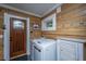 Laundry room features wood paneling, matching washer/dryer, and storage at 3970 Betsy Kerrison Pkwy, Johns Island, SC 29455