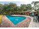 A stunning pool with a red brick border surrounded by lush greenery and lounge chairs; an entertainer's dream at 3970 Betsy Kerrison Pkwy, Johns Island, SC 29455