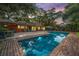 An outdoor pool with a red brick border surrounded by lush greenery; perfect for relaxation or Gathering fun at 3970 Betsy Kerrison Pkwy, Johns Island, SC 29455