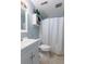 Clean bathroom featuring a vanity with sink, toilet, and tub/shower combo with a white shower curtain at 40 Bee Street # 314, Charleston, SC 29403