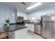 Bright kitchen featuring modern appliances, white cabinets, and a breakfast bar for convenient dining at 40 Bee Street # 314, Charleston, SC 29403