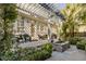 Outdoor living space with a pergola, seating, water feature, and lush greenery at 40 New St, Charleston, SC 29401