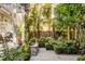 Beautiful backyard garden with a stone pathway and lush landscaping at 40 New St, Charleston, SC 29401