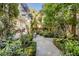 Lush backyard featuring a stone pathway, pergola, and meticulously manicured greenery at 40 New St, Charleston, SC 29401