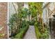 Backyard path featuring lush landscaping and a serene escape from the city at 40 New St, Charleston, SC 29401