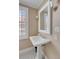 Pedestal sink in a classic bathroom with wainscotting and black and white checkered tile floor at 40 New St, Charleston, SC 29401