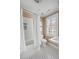 Classic bathroom featuring tiled shower, toilet, vanity, and a black and white checkered tile floor at 40 New St, Charleston, SC 29401