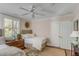 Bright bedroom featuring one of two beds, neutral color palettes, shuttered windows and stylish furnishings at 40 New St, Charleston, SC 29401