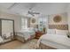 Bright bedroom featuring two beds, neutral color palettes, shuttered windows and stylish furnishings at 40 New St, Charleston, SC 29401
