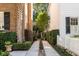 Private driveway entrance with manicured hedges and lush landscaping between homes at 40 New St, Charleston, SC 29401