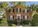 Charming two-story brick home with black shutters and well-manicured landscaping at 40 New St, Charleston, SC 29401