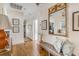 Hallway featuring wood floors, stylish decorations, and an inviting open doorway at 40 New St, Charleston, SC 29401