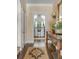 Inviting hallway with hardwood floors leads to a bright kitchen, showcasing classic design elements at 40 New St, Charleston, SC 29401