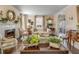 Bright living room with a fireplace, classic furnishings, and an open layout at 40 New St, Charleston, SC 29401