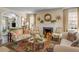 Comfortable living room with a fireplace, decorative mirror, and neutral tones at 40 New St, Charleston, SC 29401
