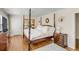 Spacious primary bedroom with four poster bed, hardwood floors, and decorative wall accents at 40 New St, Charleston, SC 29401
