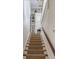 Carpeted staircase with built-in shelving units, decorated with various dishware and vases at 40 New St, Charleston, SC 29401