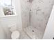 Modern bathroom featuring a walk-in shower with marble tile and a window for natural light at 405 Simmons Ave, Summerville, SC 29483