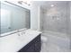 Bright bathroom features vanity with double mirror and sink, toilet and tub-shower with modern fixtures at 405 Simmons Ave, Summerville, SC 29483