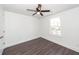 Bright bedroom with a ceiling fan and a window overlooking a neighborhood street, featuring modern vinyl plank flooring at 405 Simmons Ave, Summerville, SC 29483