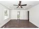 Bright bedroom showing hardwood floors, ceiling fan, and access to an en-suite bathroom at 405 Simmons Ave, Summerville, SC 29483