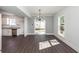 Dining area with sleek light fixture, sliding glass doors and hardwood floors at 405 Simmons Ave, Summerville, SC 29483