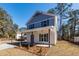 Charming two-story home featuring blue and white siding, and a welcoming front porch with modern columns at 405 Simmons Ave, Summerville, SC 29483