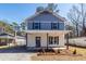 Two-story home with blue and white exterior and a well-maintained front yard and gravel driveway at 405 Simmons Ave, Summerville, SC 29483