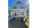Charming two-story home with a welcoming front porch, modern columns, and manicured landscaping at 405 Simmons Ave, Summerville, SC 29483