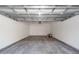 Spacious garage interior with smooth concrete flooring and neutral walls and ceilings at 405 Simmons Ave, Summerville, SC 29483