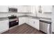 Well-lit kitchen showcasing stainless steel appliances, modern white cabinets, and granite countertops at 405 Simmons Ave, Summerville, SC 29483