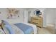 This is a staged bedroom with light wood furnishings and modern decor at 4179 Rising Tide Dr, Summerville, SC 29485