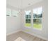Bright dining room with lake views and modern chandelier at 420 Queen View Ln, Charleston, SC 29414