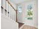 Bright foyer featuring wood stairs and a view of the exterior through the glass-paneled front door at 420 Queen View Ln, Charleston, SC 29414