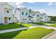 A row of pristine two-story homes each with a one-car garage and green lawn at 420 Queen View Ln, Charleston, SC 29414