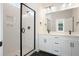Modern bathroom features double vanity, white tile shower, and black accents at 422 Queenview Ln, Charleston, SC 29414