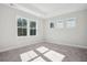 Sunlit bedroom with soft gray carpet, neutral walls, and large windows at 422 Queenview Ln, Charleston, SC 29414