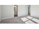Spacious bedroom with soft gray carpet leading to a bathroom at 422 Queenview Ln, Charleston, SC 29414