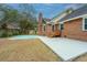 Backyard featuring a brick house, patio, and partially covered pool area at 476 E Wimbledon Dr, Charleston, SC 29412