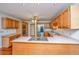 Spacious kitchen featuring light wood cabinets, stainless steel appliances, and a central island cooktop at 476 E Wimbledon Dr, Charleston, SC 29412