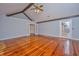 Spacious living room featuring vaulted ceilings, exposed wood beams and glossy hardwood floors at 476 E Wimbledon Dr, Charleston, SC 29412